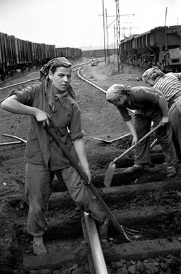 Poland. Bytom. 1956. yuong woman restoring rails into a landmine.